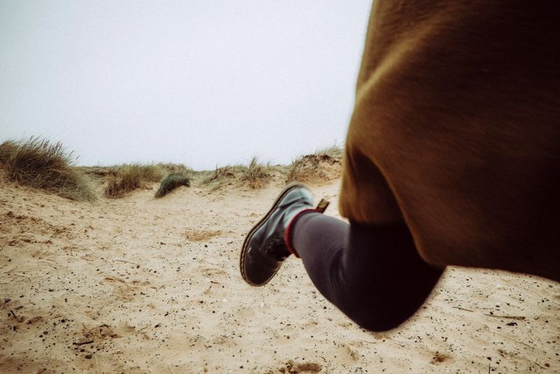 A runner on a sandy track on a bright day